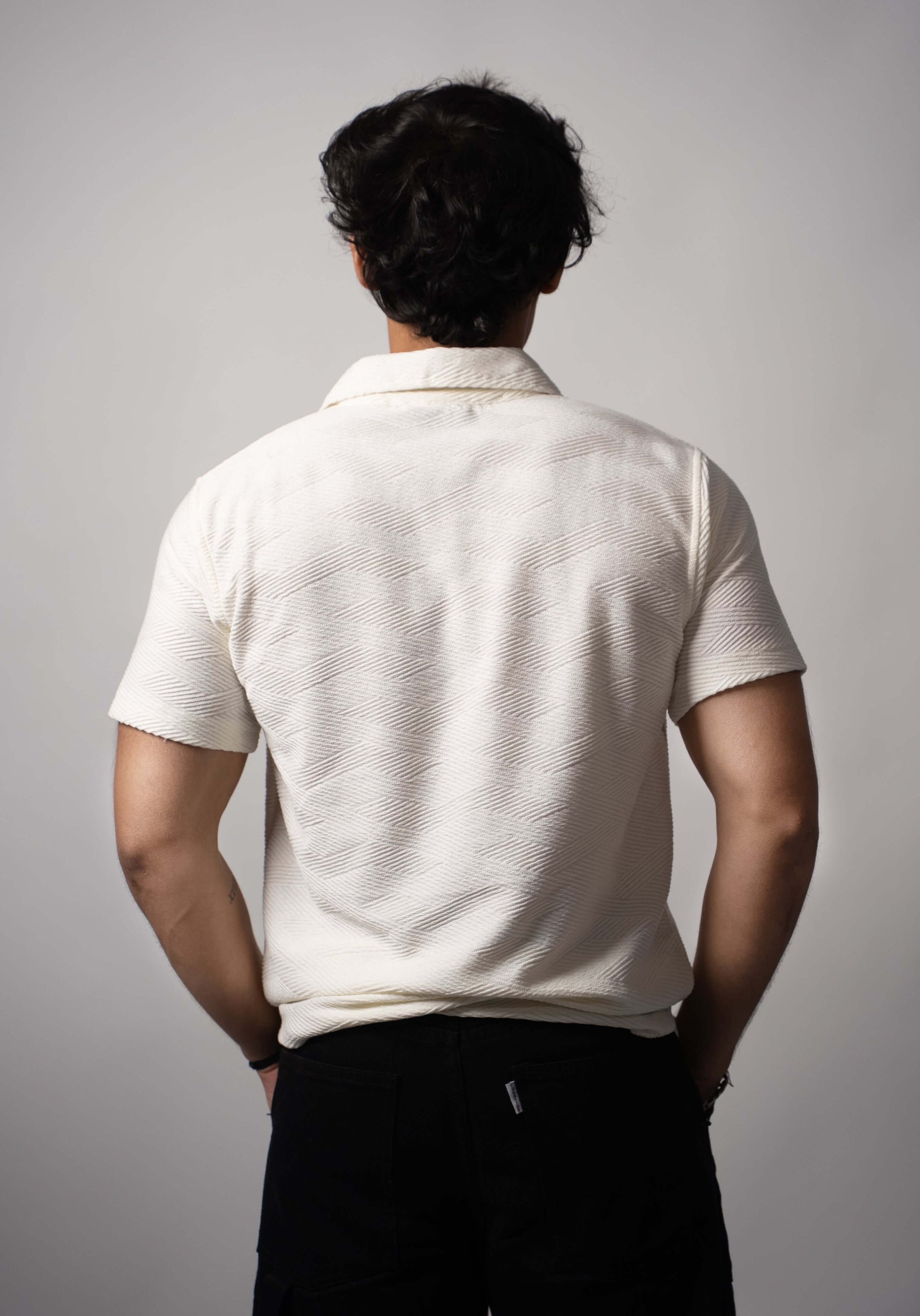 Back view of white Jacquard polo with soft bio-washed finish